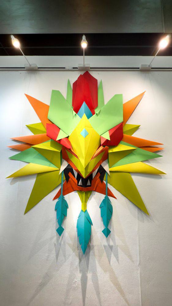 Large sculptural paper mask installation by André Minato